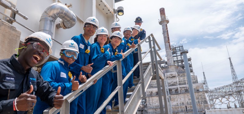 Summit students standing on staircase at refinery